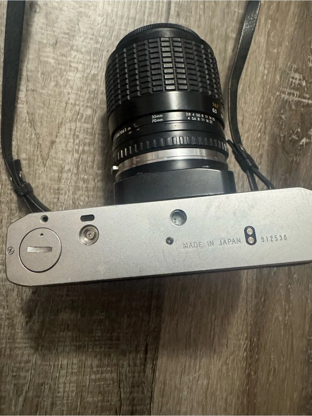 Olympus OM-10 35mm SLR Camera in Silver and Black with Telephoto Lens